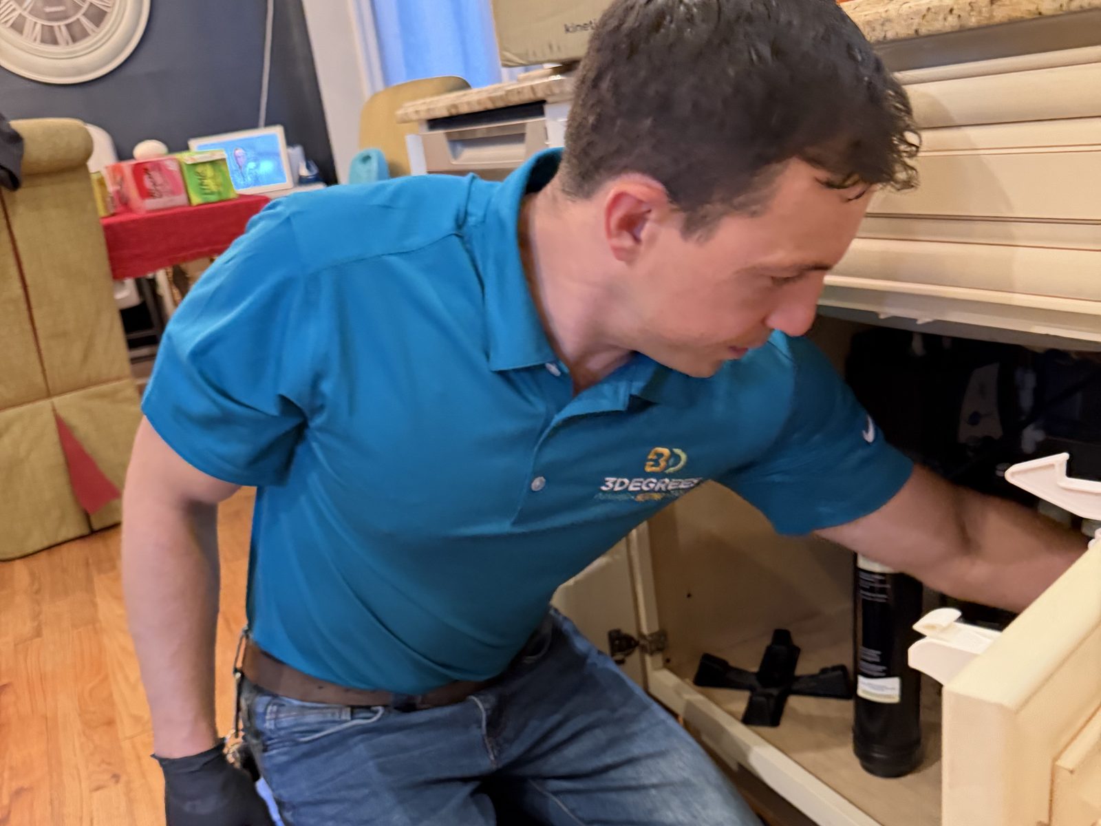 3Degrees technician performing plumbing repair under a sink